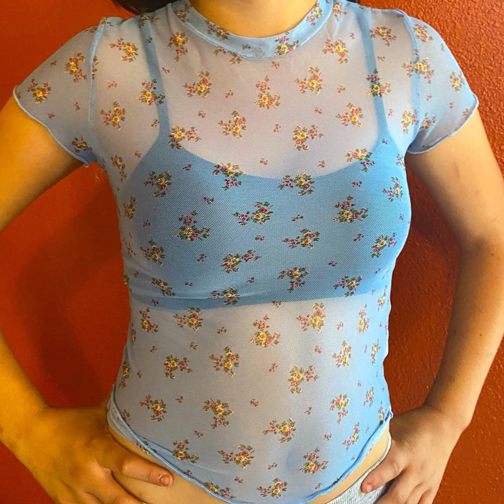 Shirt is multi colored and see through